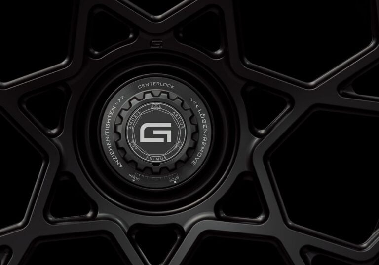 Three-quarter view of a black G67 2-piece centerlock wheel from Govad Forged Carbon8 series with carbon fiber lip