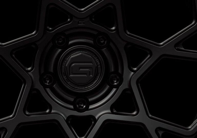 Three-quarter view of a black G67 2-piece wheel from Govad Forged Carbon8 series with carbon fiber lip